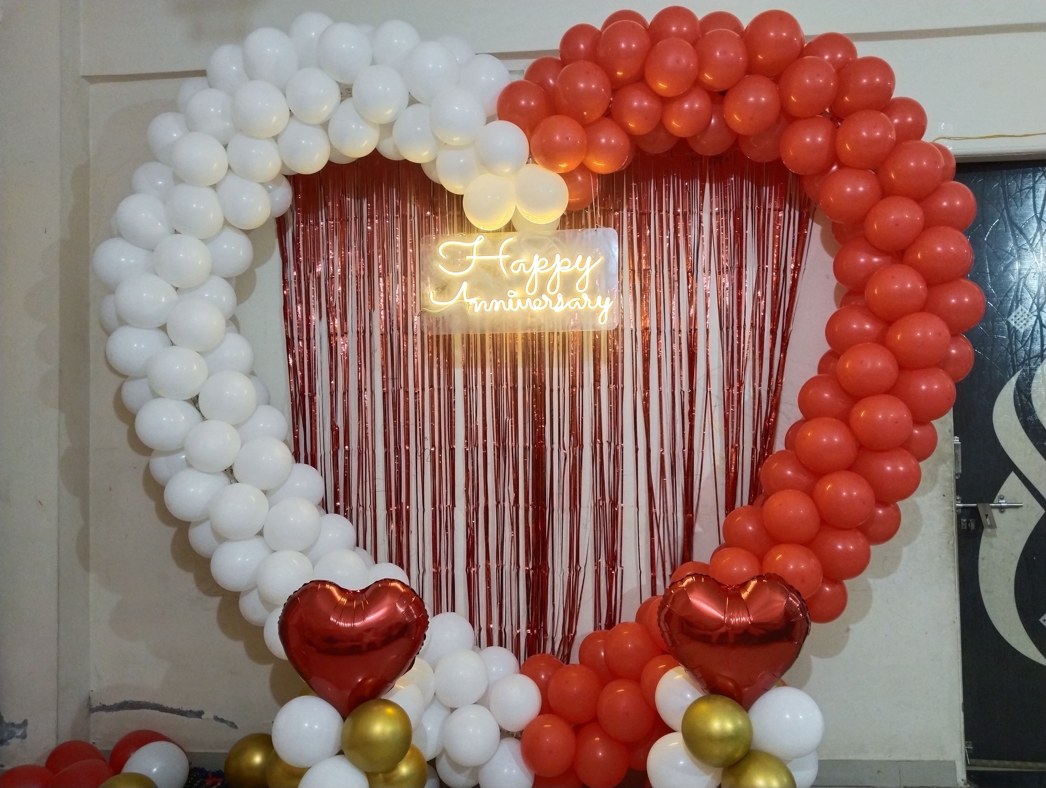 Elegant anniversary party decoration with balloons, flowers and event lighting